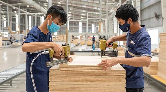 Thợ mộc sử dụng súng bắn đinh khí nén để lắp ráp khung gỗ